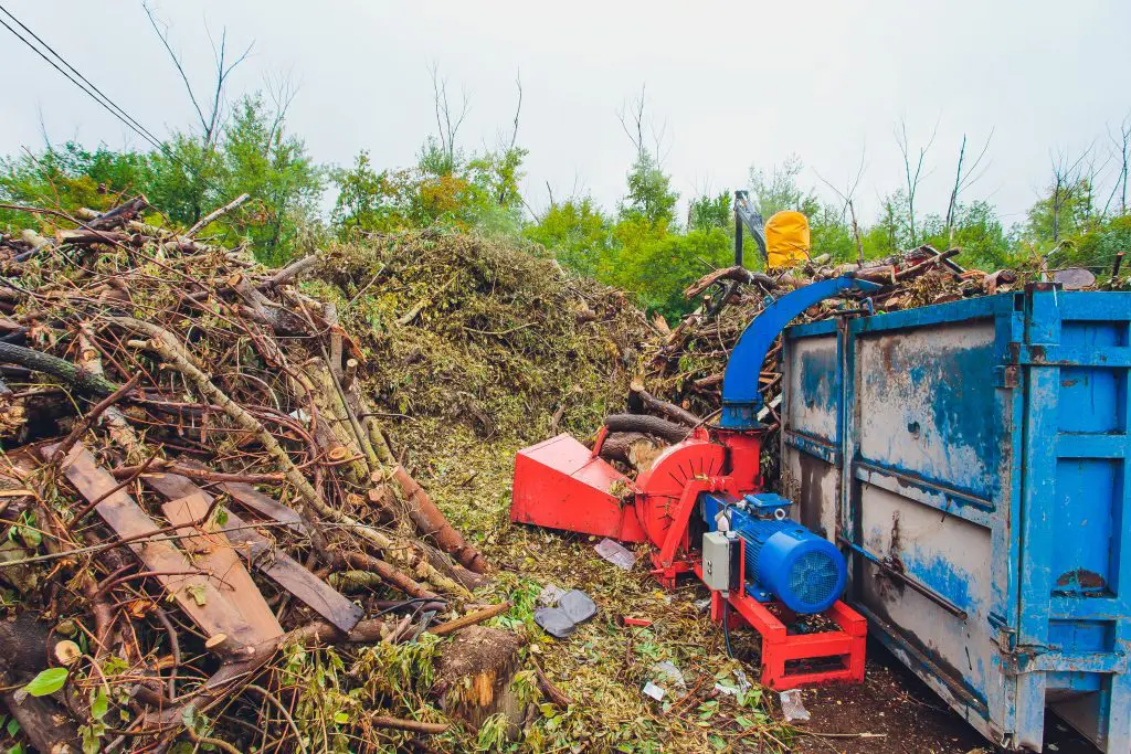 A hopper full of mulch is being processed on site