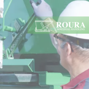 An operator has his hands on the safety latch of a self-dumping hopper