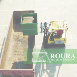 An operator holds a Roura rotator box on a forklift and is positioning it above a container