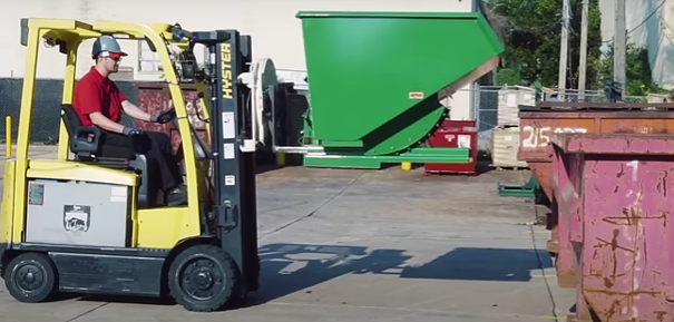 Man operating a forklift with a hopper